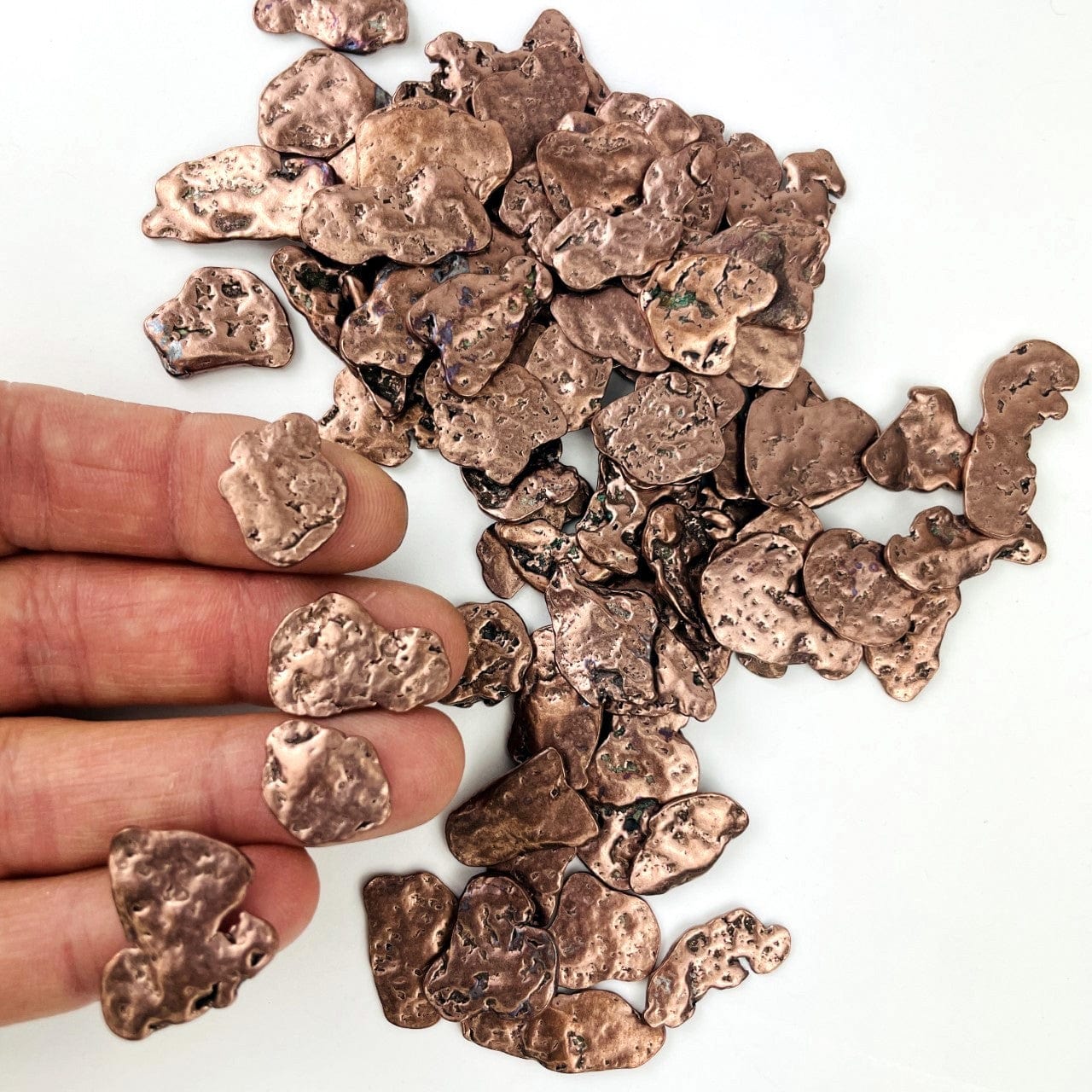 Copper Nuggets - Freeform Shapes with 4 on a hand for size reference