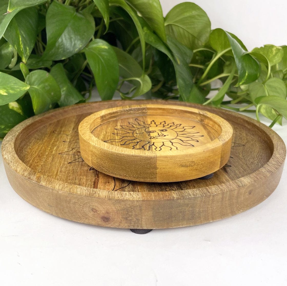 small and large mango wood trays with sun and moon design etched in black on a white background