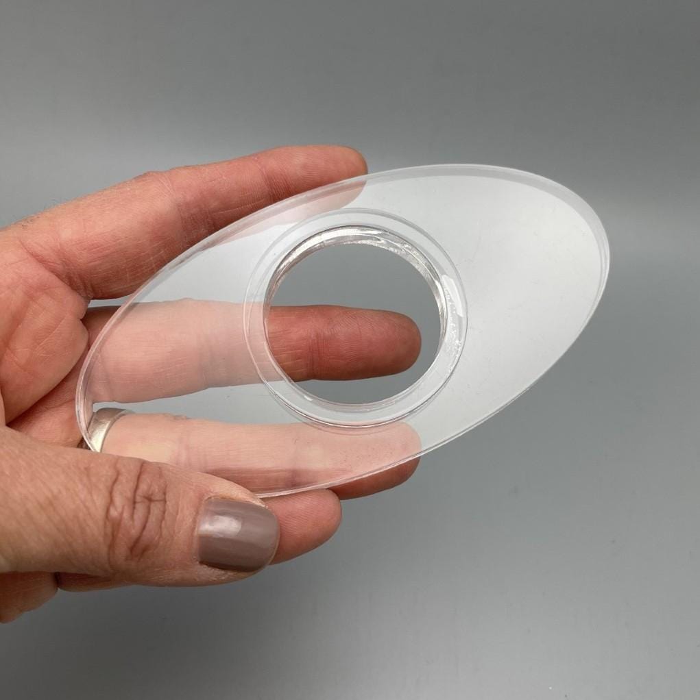 Acrylic Sphere Holder - Clear Oval Holder shown in a hand.