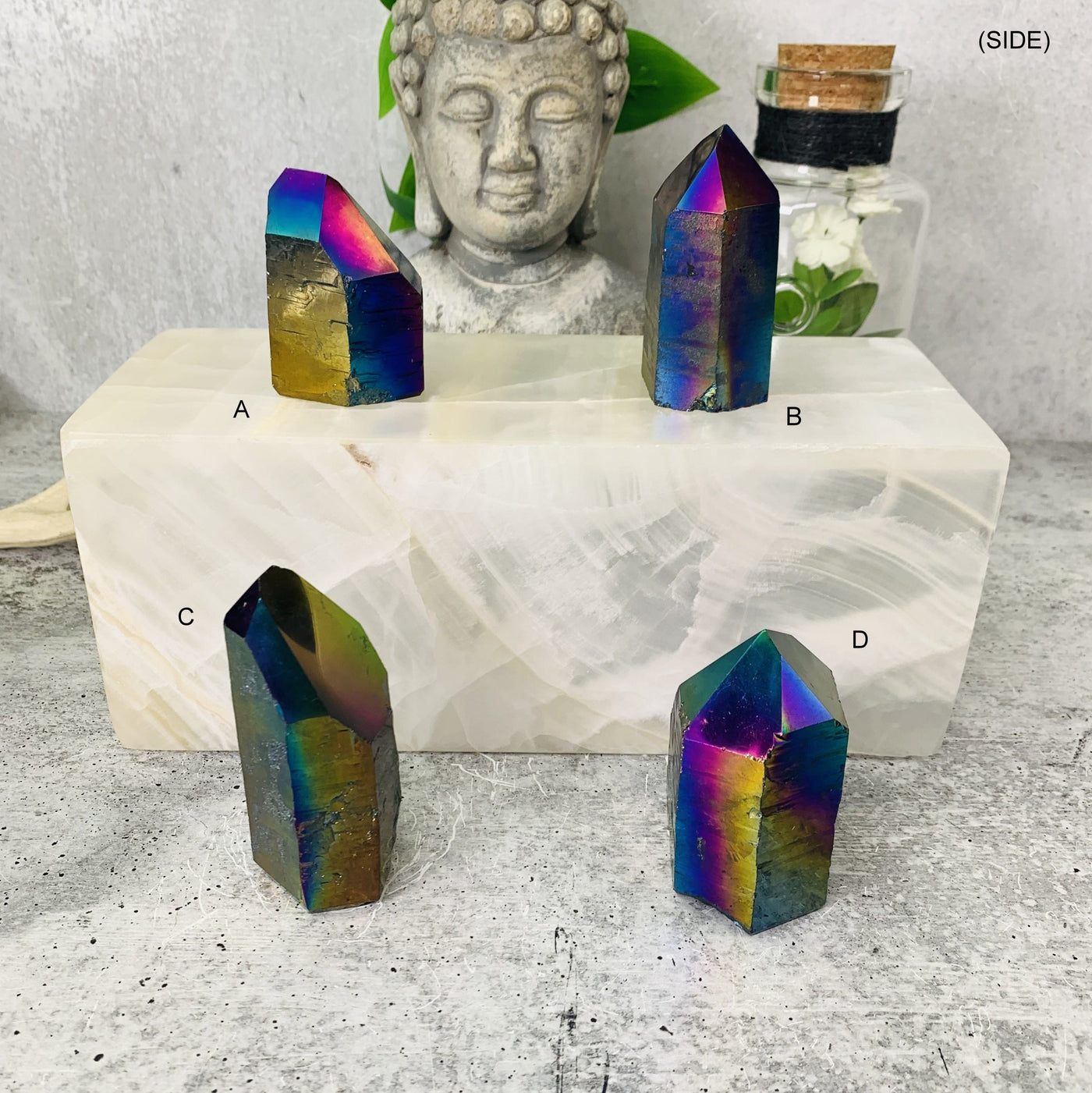 This picture is showing the side view to all the rainbow titanium points available for this Listing, Titanium Points are also being displayed on a White marbled surface and Grey marbled back ground.