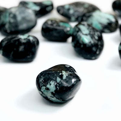 Emerald Freeform Tumbled Polished Stone displayed different size on a whit background