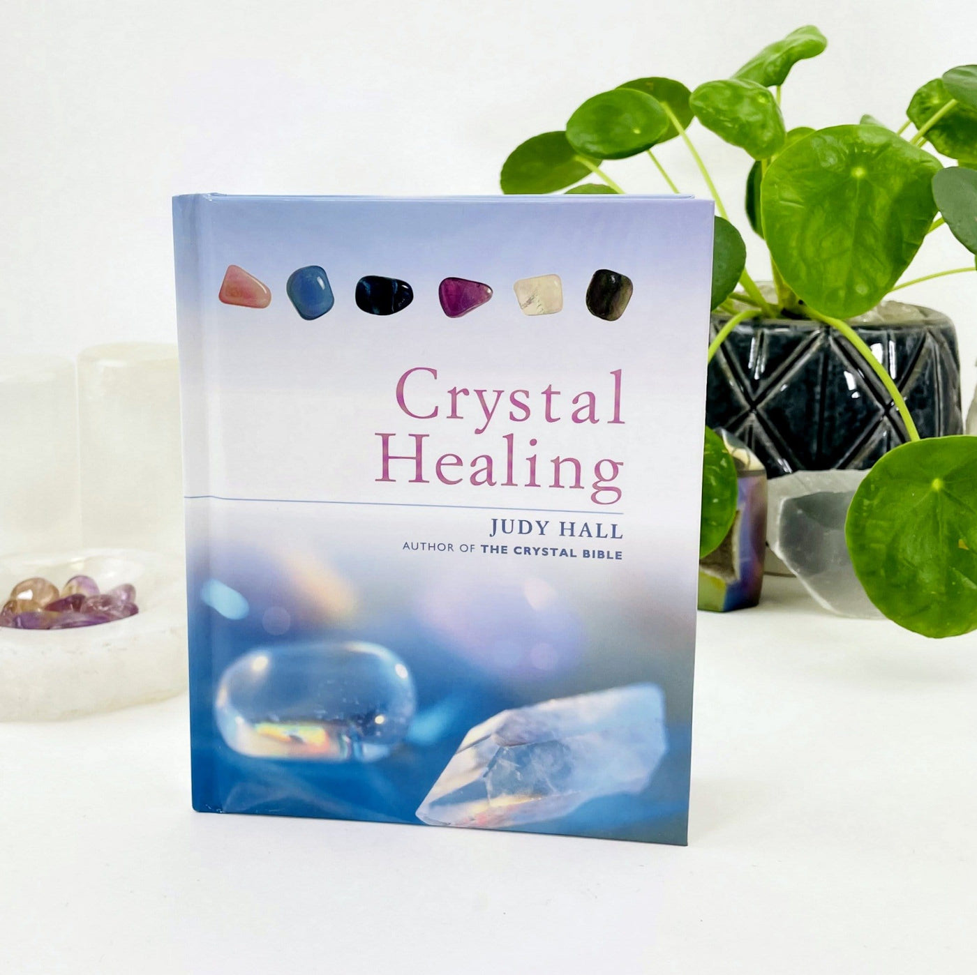Crystal Healing by Judy Hall with decorations in the background