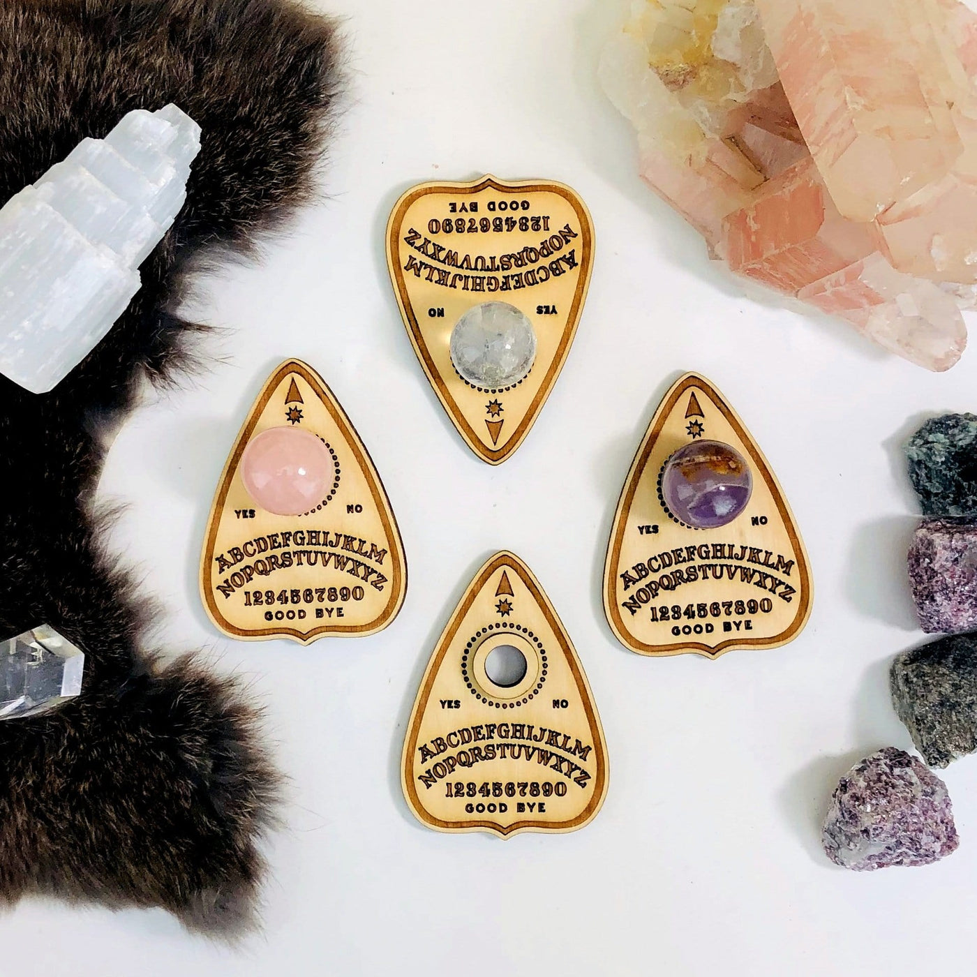 4 Planchette Light Wooden Sphere Stand on display with a small sphere in Rose quartz , Crystal quartz, and Amethyst .