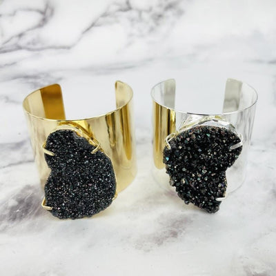 freeform Black Diamond Titanium Druzy Bracelet with Electroplated Adjustable Cuff in gold and silver displayed on white background