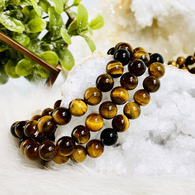 Tigers Eye Round Bead Bracelets 8mm. Tiger Eye has lovely bands of yellow-golden color through silky lusters of brown to red color. Tigers Eye is known as the “POWER STONE”. This is a powerful stone that aids harmony and balance, helping to release anxiety and fear.