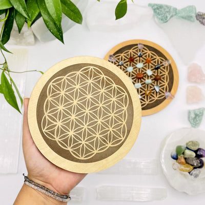 wooden flower of life grid in a hand