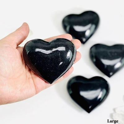 black onyx heart in a hand