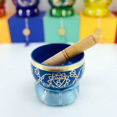 Brass Tibetan Singing Bowls - light blue bowl on a table