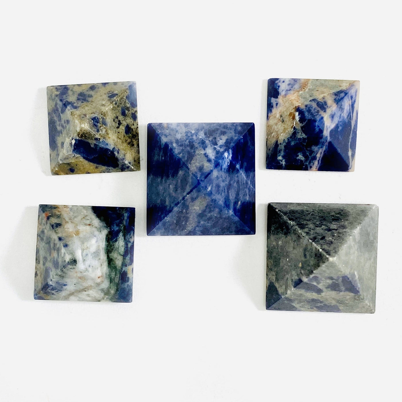 overhead view of vide sodalite pyramids on white background for possible variations 