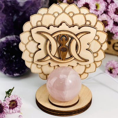 Earth Goddess and Moon Wooden Sphere Stand Lamp with flowers on a background 