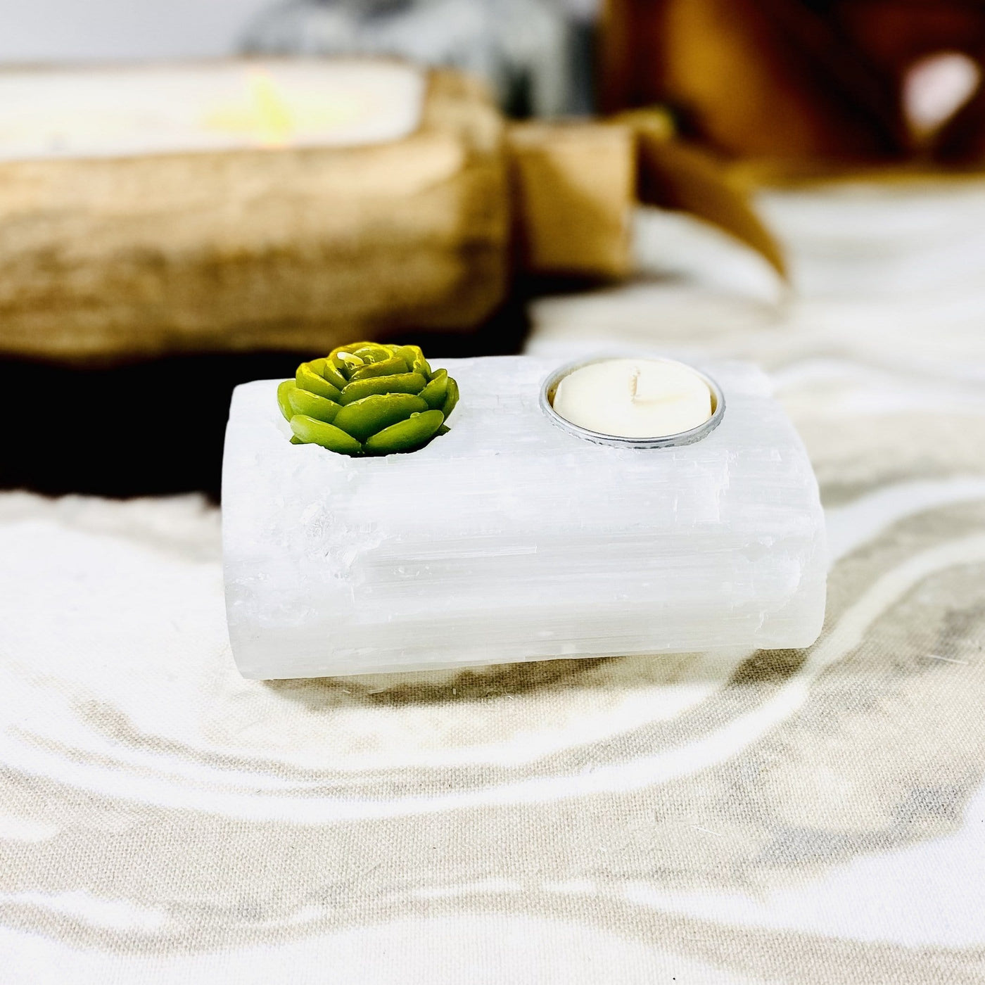 selenite log candle holder on display with candles (not included with purchase)