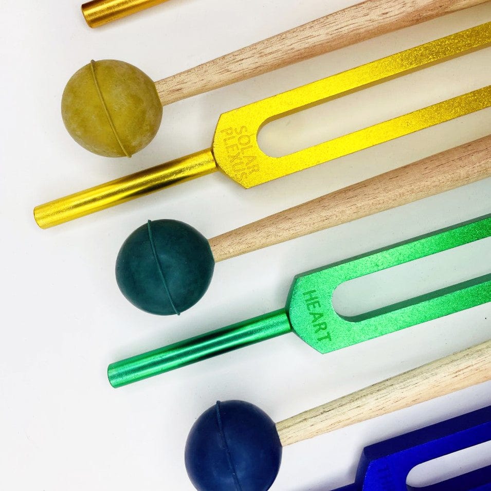 Close up of the Green Yellow and Blue Tuning Fork and Mallet