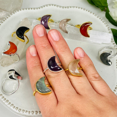 gemstone ring in hand for size reference. you select the ring size and gemstone type 
