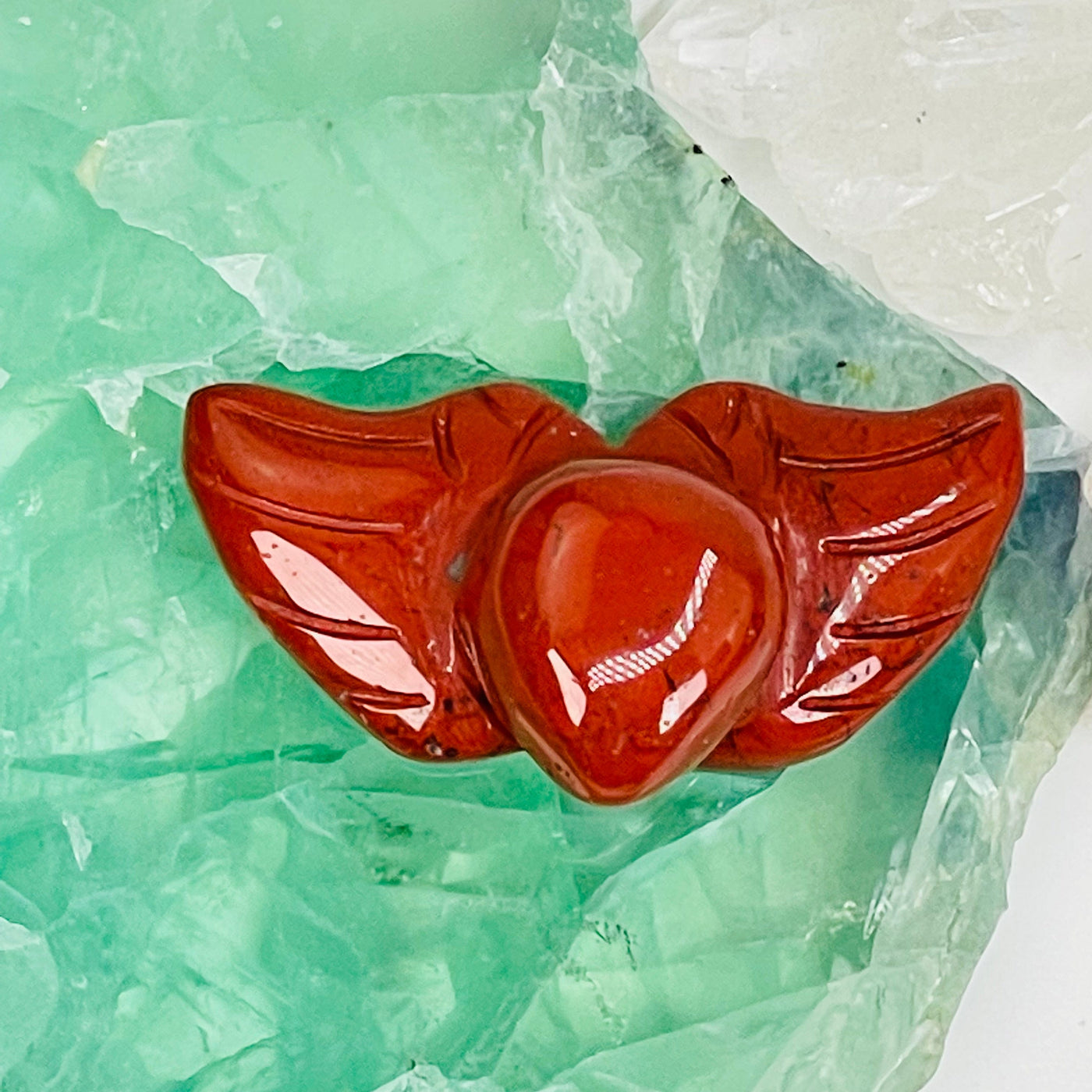 red jasper heart with wings displayed as home decor 