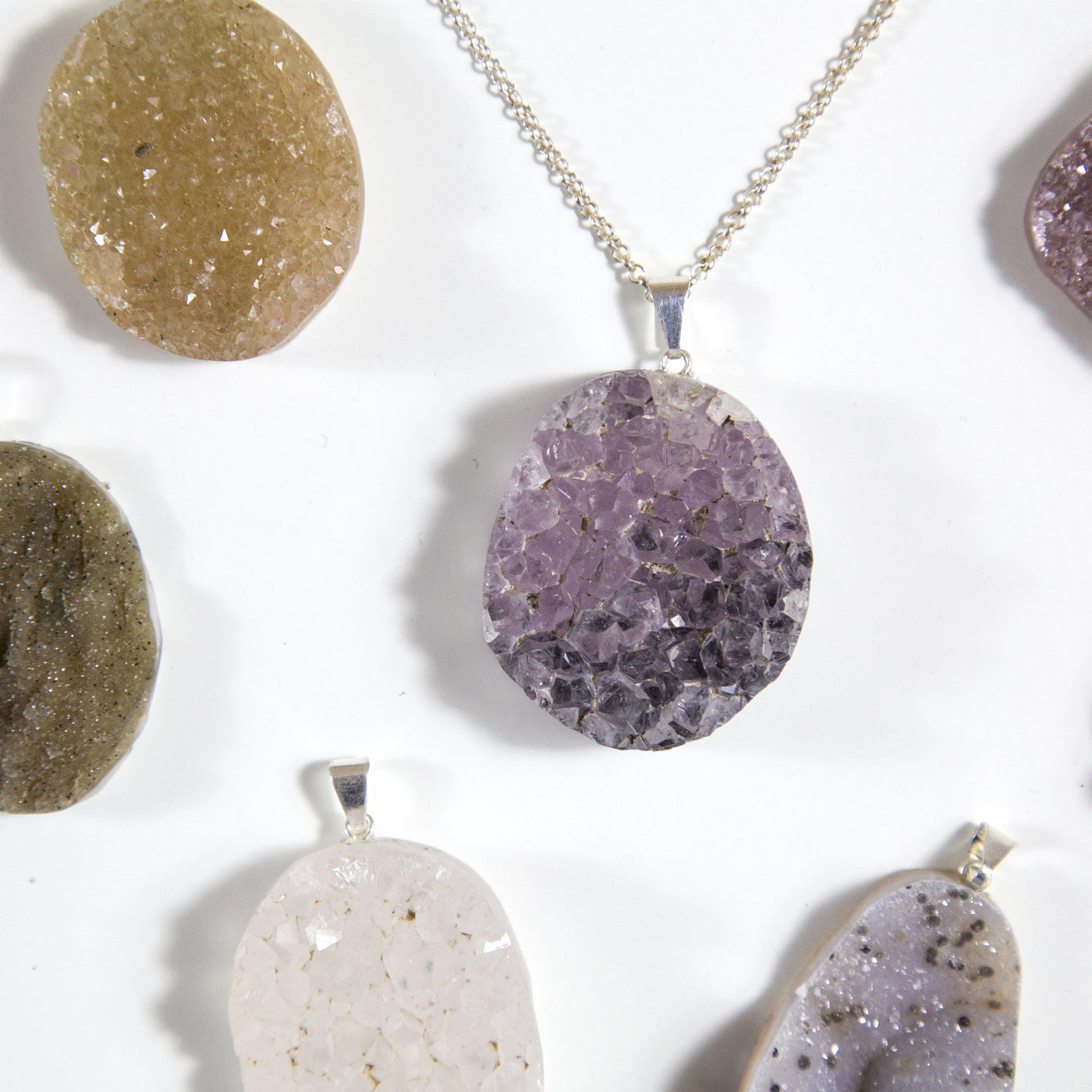 up close shot of druzy cabochon pendant on necklace chain
