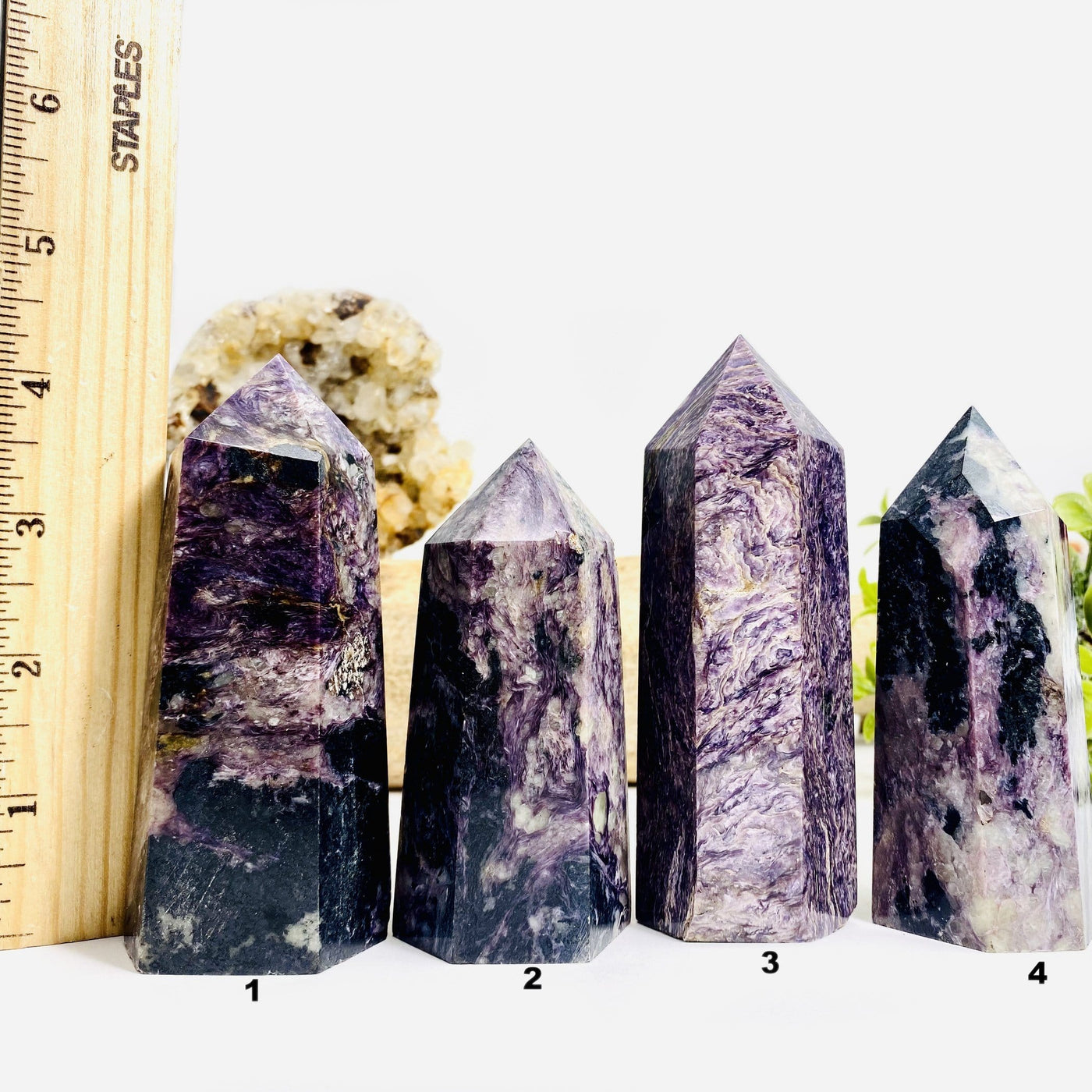 4 Charoite Polished Towers next to a ruler for size reference