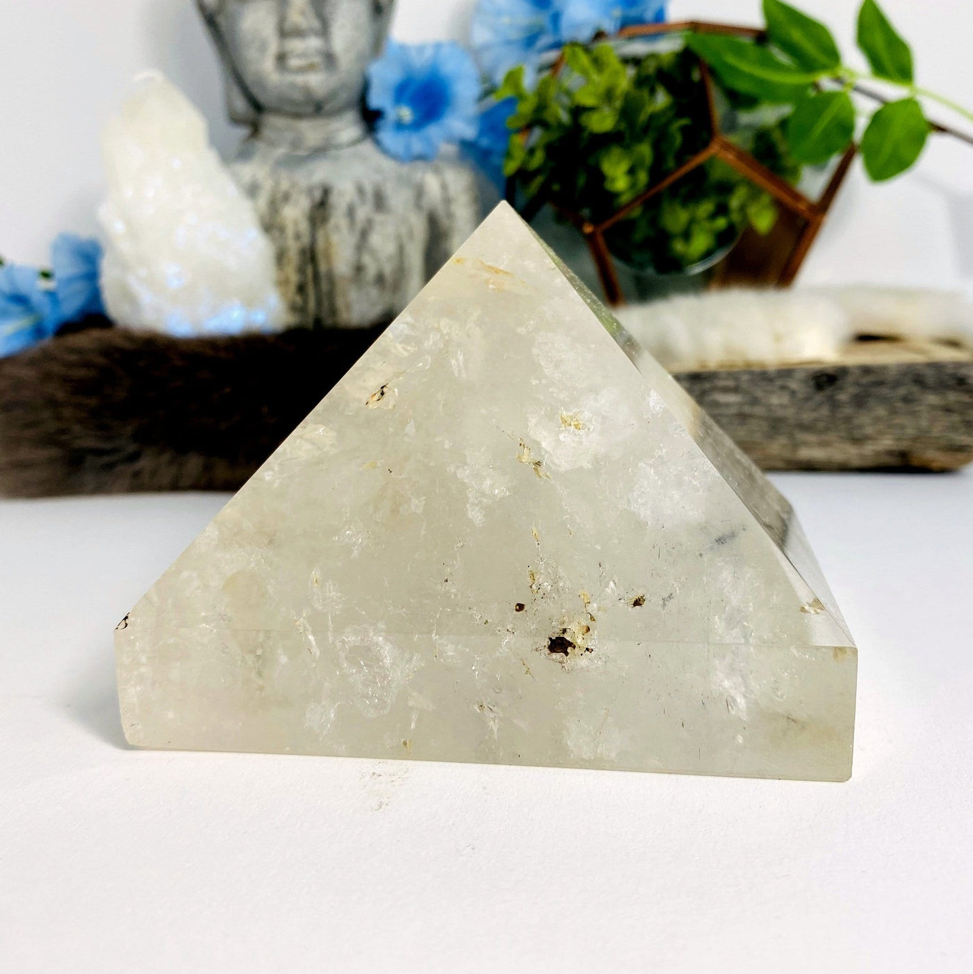 Crystal Quartz Pyramid with decorations in the background