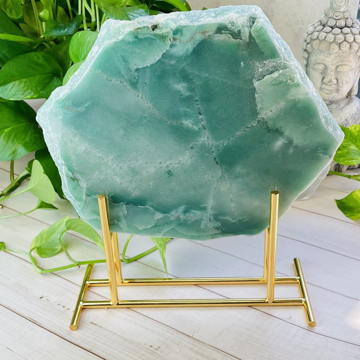 Display Stand Gold Color With Aventurine Platter on Wooden Background.
