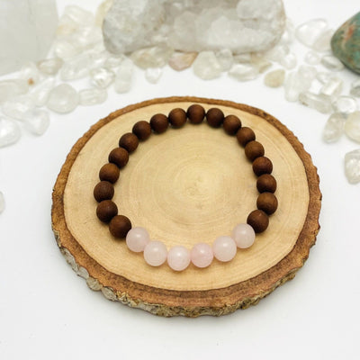 one sandalwood bead bracelet with rose quartz on display for details