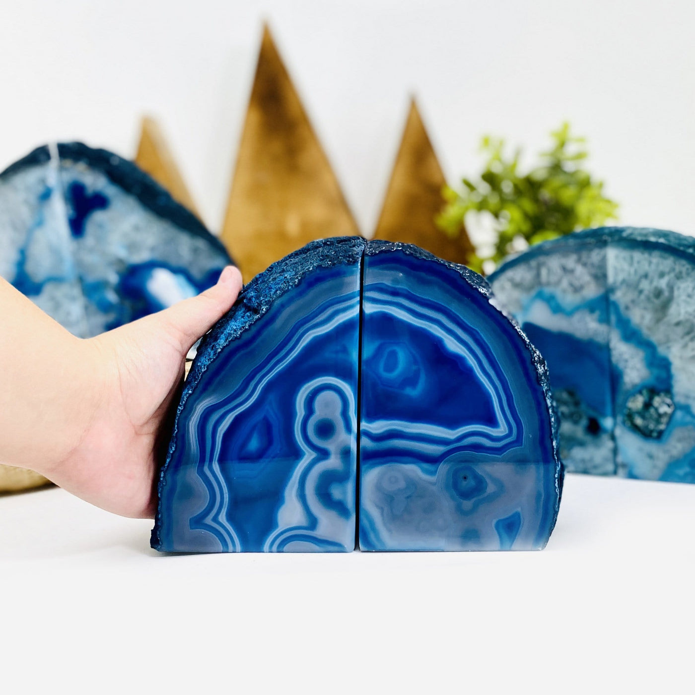 blue agate bookend with a hand next to it