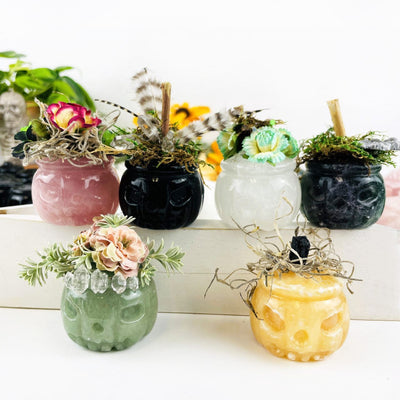 various stones carved pumpkins, displayed with moss and ribbons and small crystals to give an idea of what you can do with your injured pumpkin