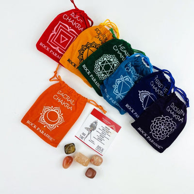 The Sacral Chakra Pouch opened up with the stones and information card beside and all the other pouches behind