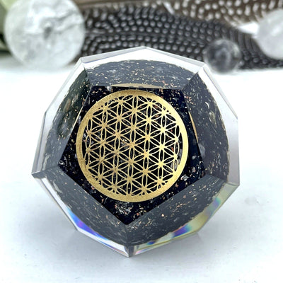 Orgone Black Tourmaline Dodecahedron shaped displayed up close to view details of flower of life grid