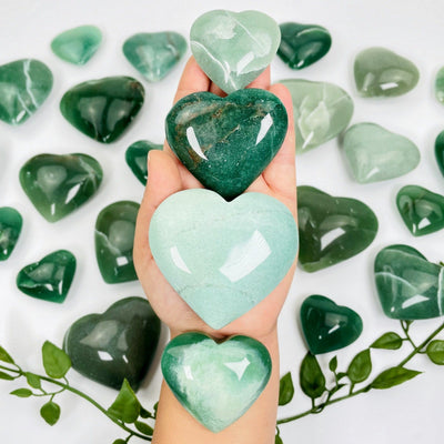 4 green hearts in a hand