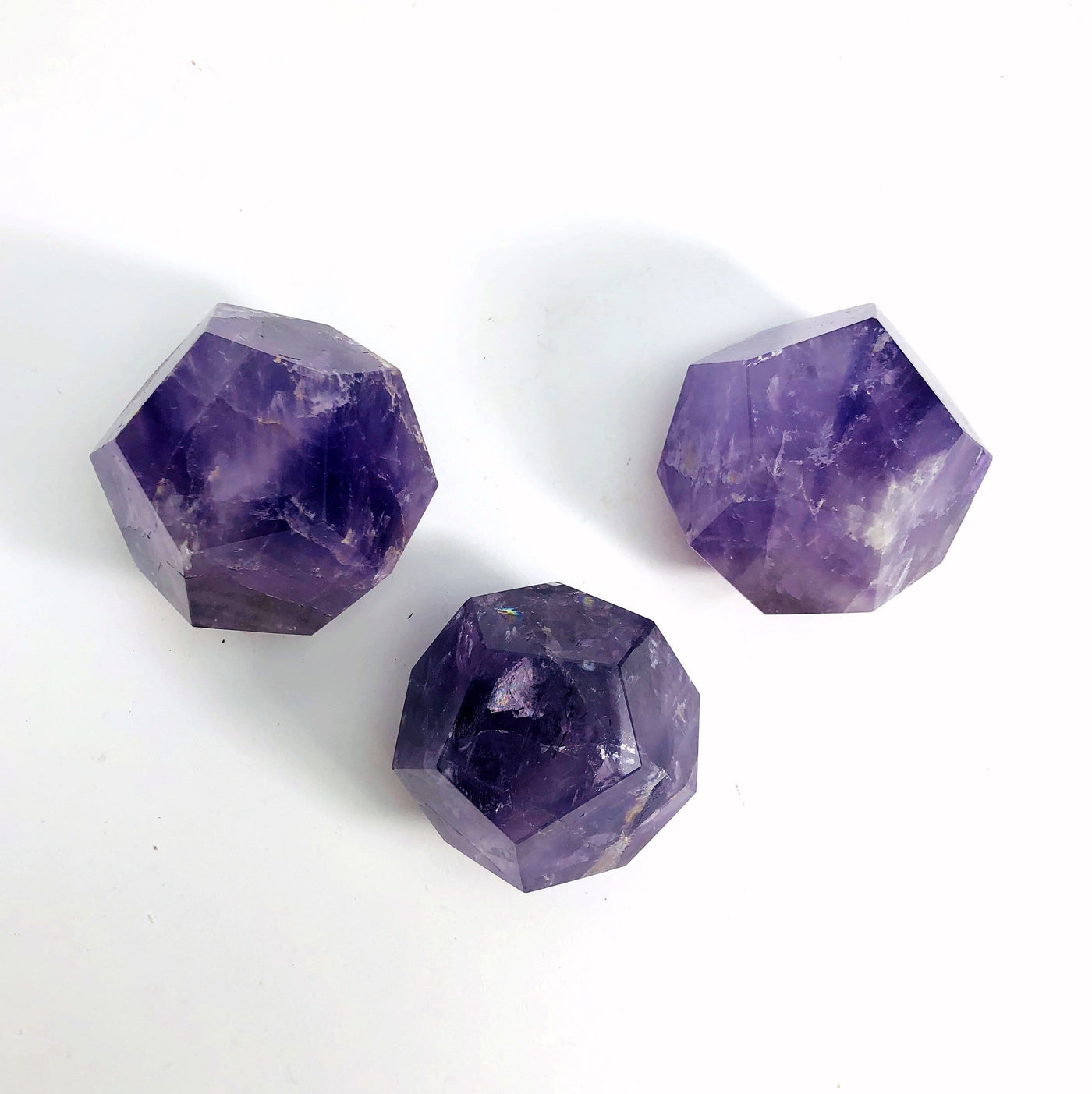 3 Amethyst Dodecahedrons on white background
