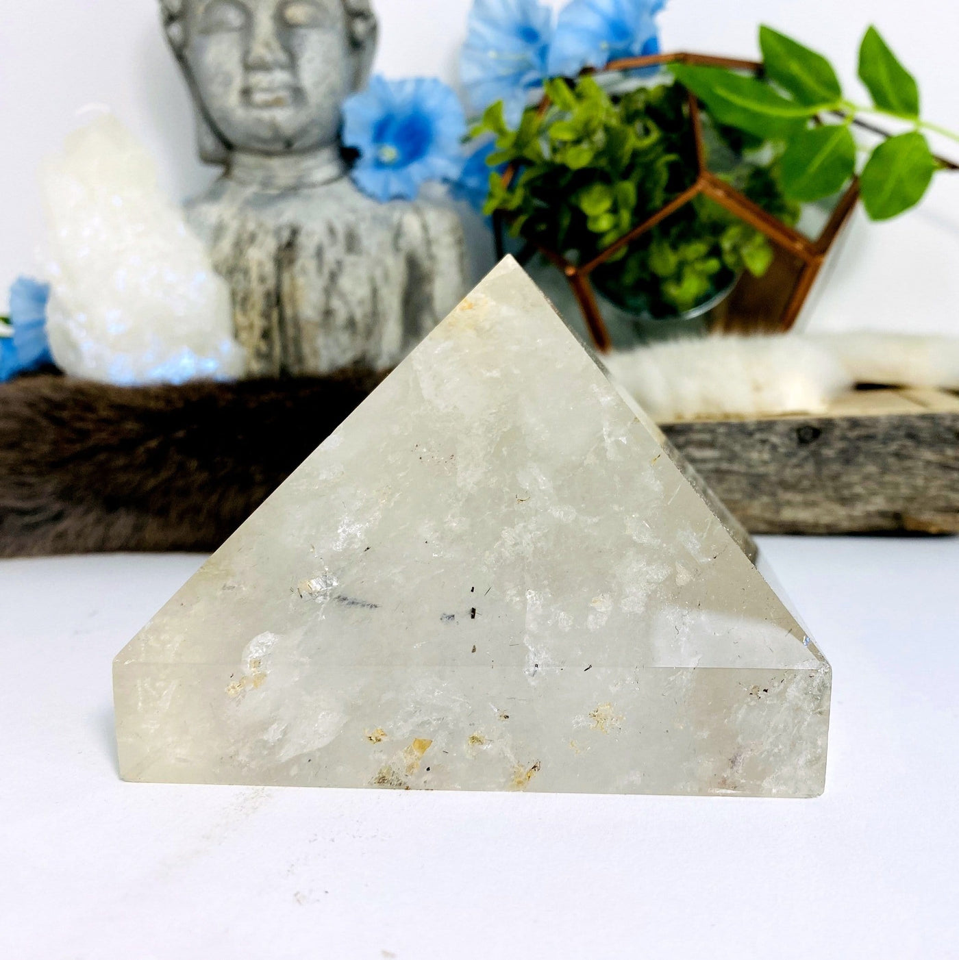 Crystal Quartz Pyramid with decorations in the background