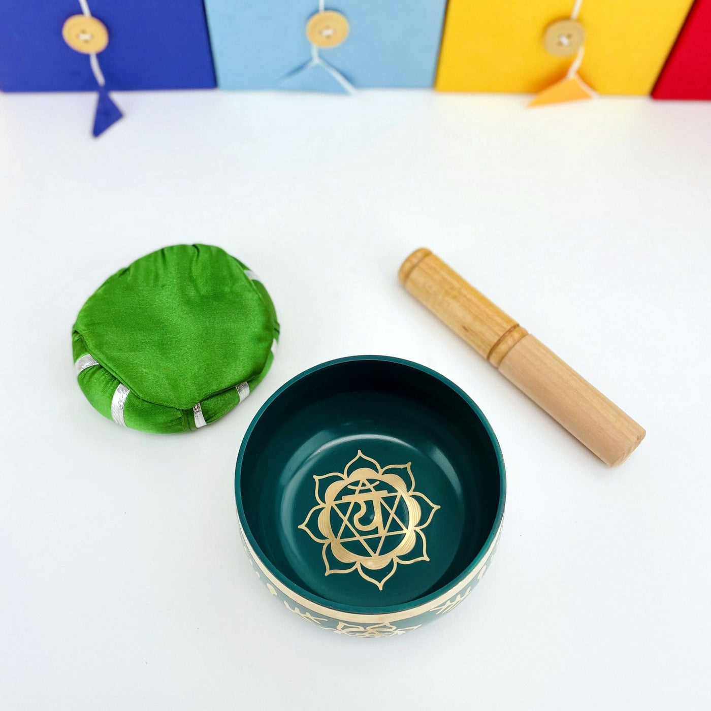 Brass Tibetan Singing Bowls - green bowl on a table