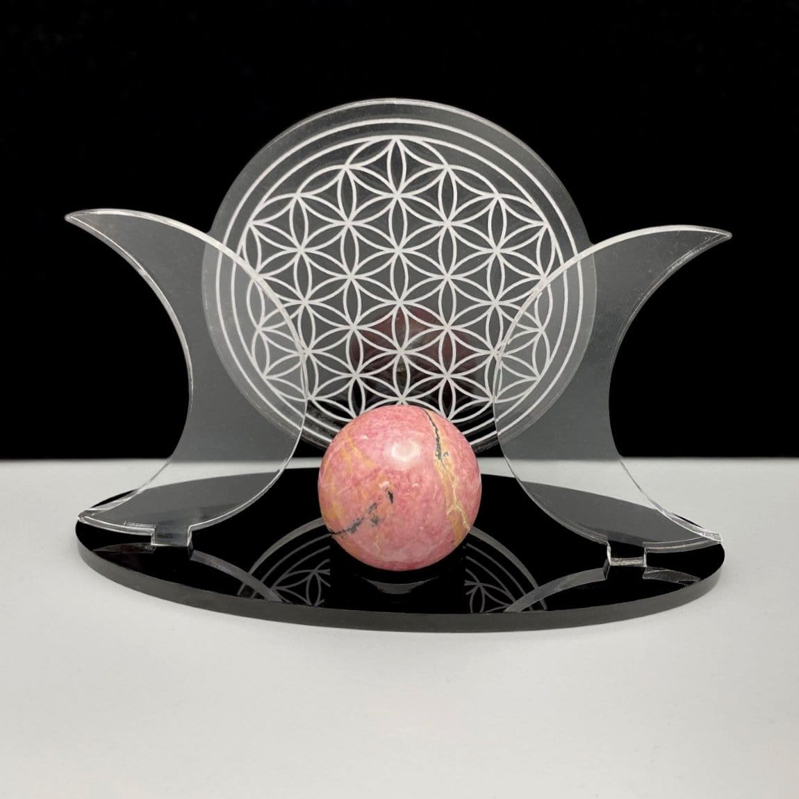Close up of Acrylic Sphere Holder Crescent Moons with Flower of Life holding a sphere.