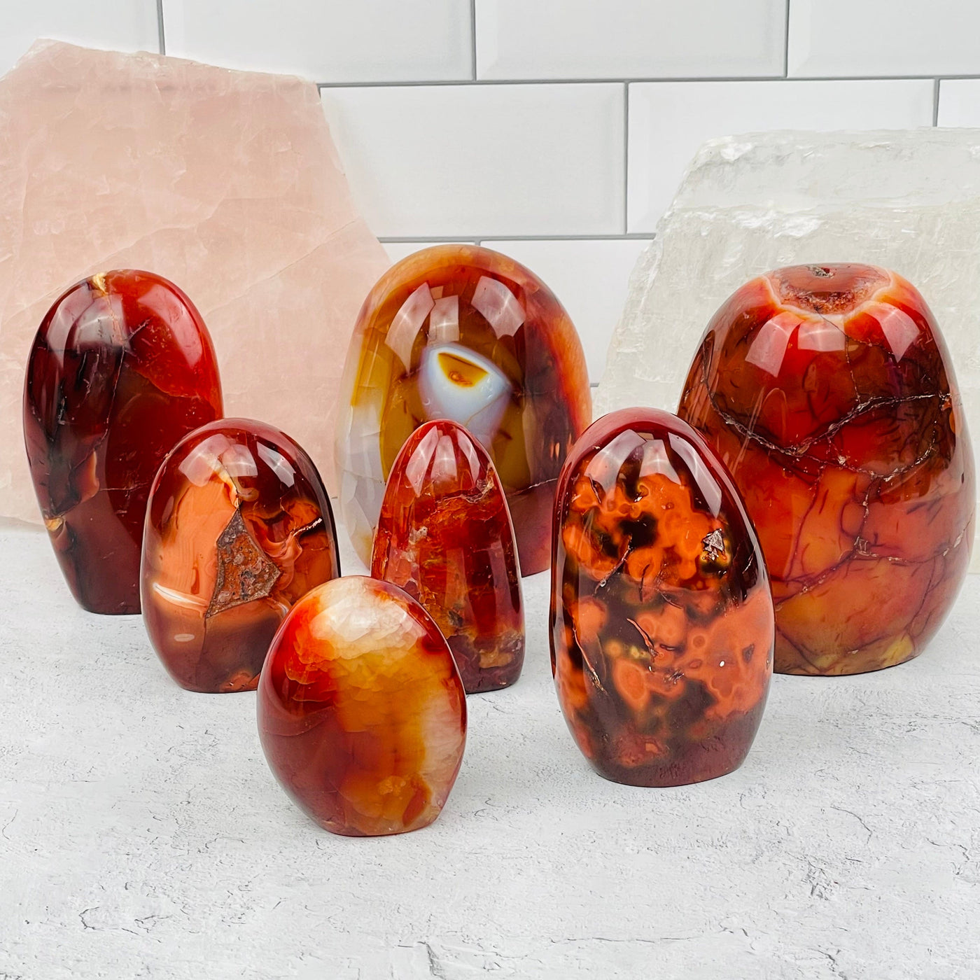 multiple carnelian polished cut base displayed to show the differences in the sizes and color patterns  