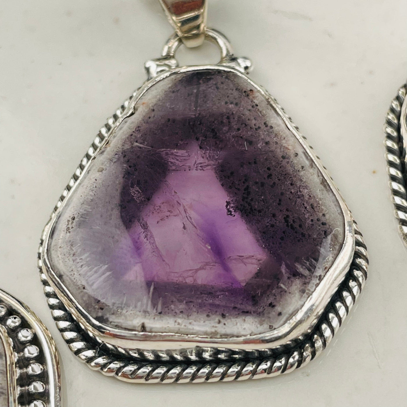 close up of the details on this Trapiche Amethyst with Matrix pendant 