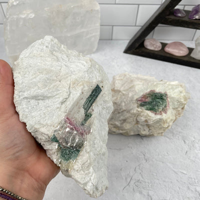 watermelon tourmaline cluster in hand for size reference 