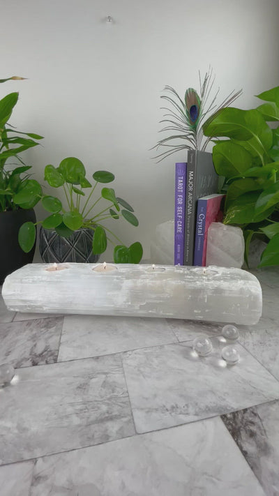 video of 4 votive selenite candle holder with hand for size reference 