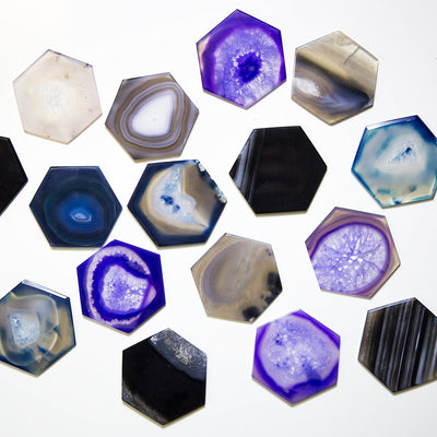 multiple hexagon shaped quartz slices displayed to show the differences in the colors available 
