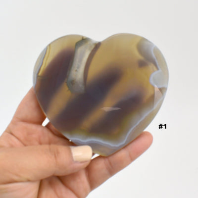 Close up of agate heart slice #1 in a hand.