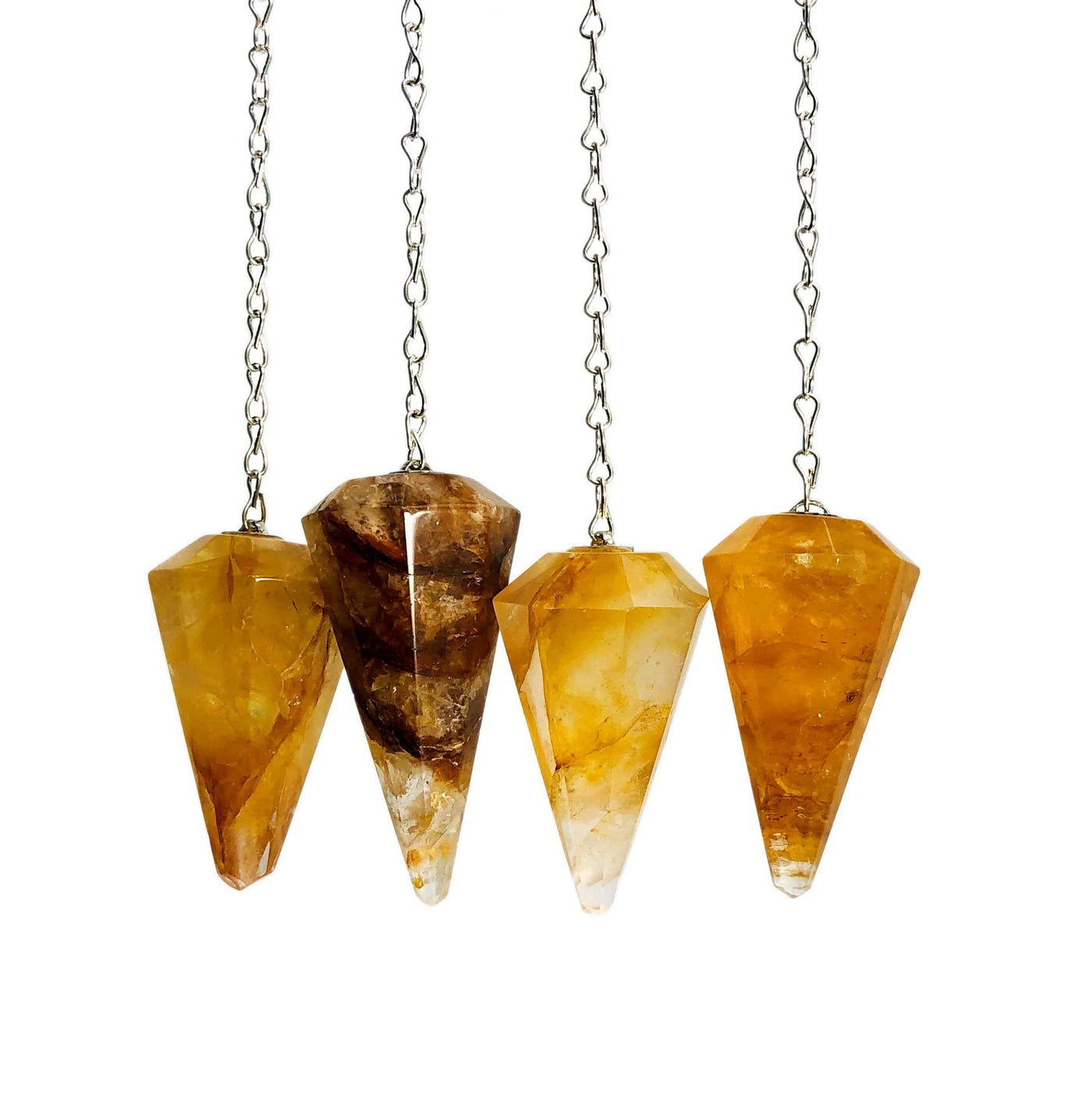 4 golden healer quartz pendulums on white background