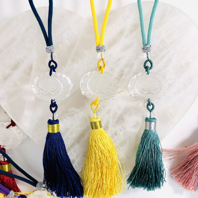 3 Lotus Flower Colored Tassels in Blue, Yellow, and Teal on A selenite heart 