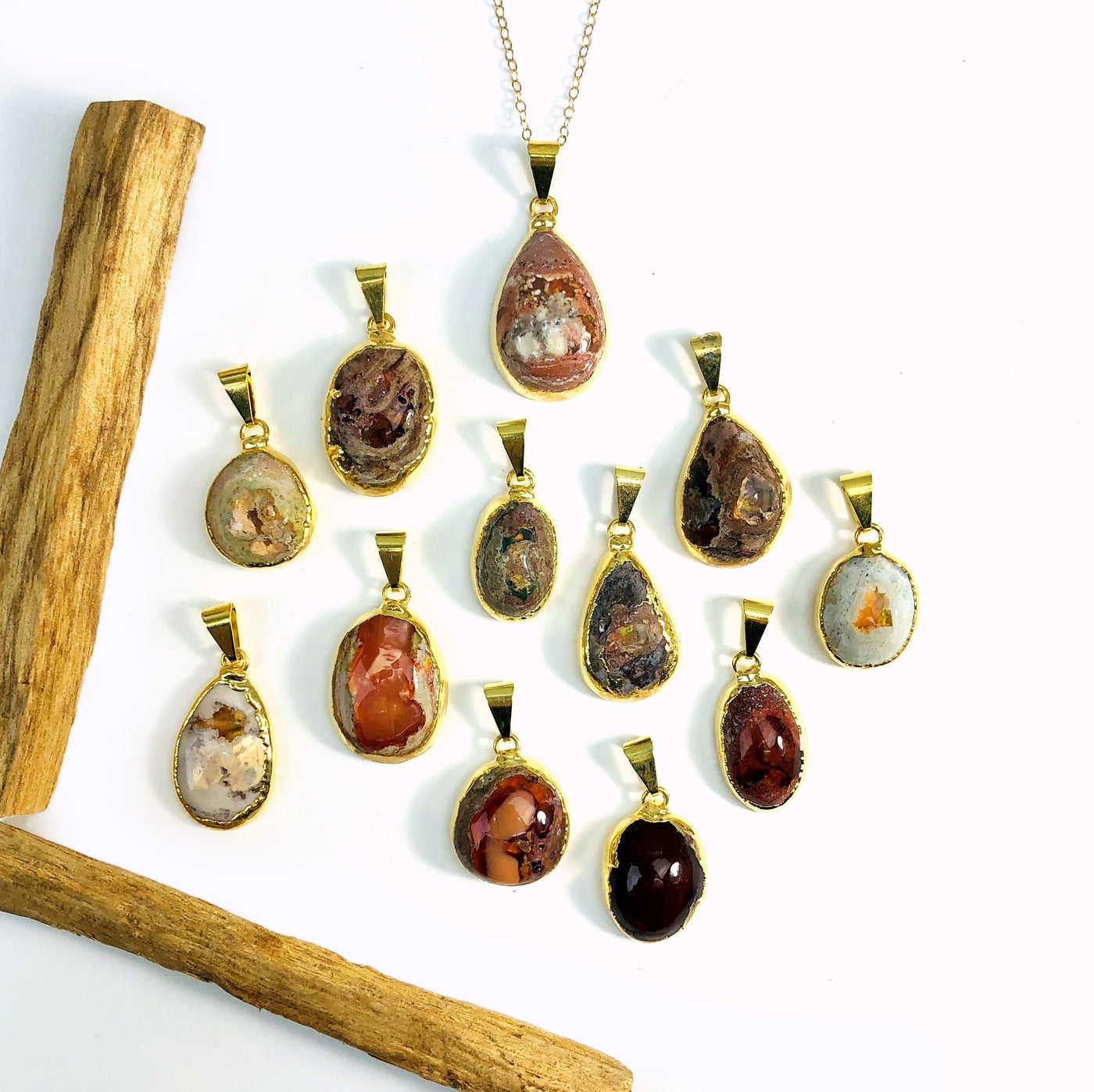 Mexican opal pendants in gold on white background
