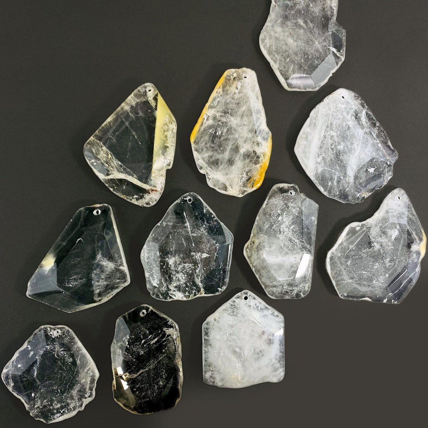 Crystal Quartz Drilled Pendants spread out on a table