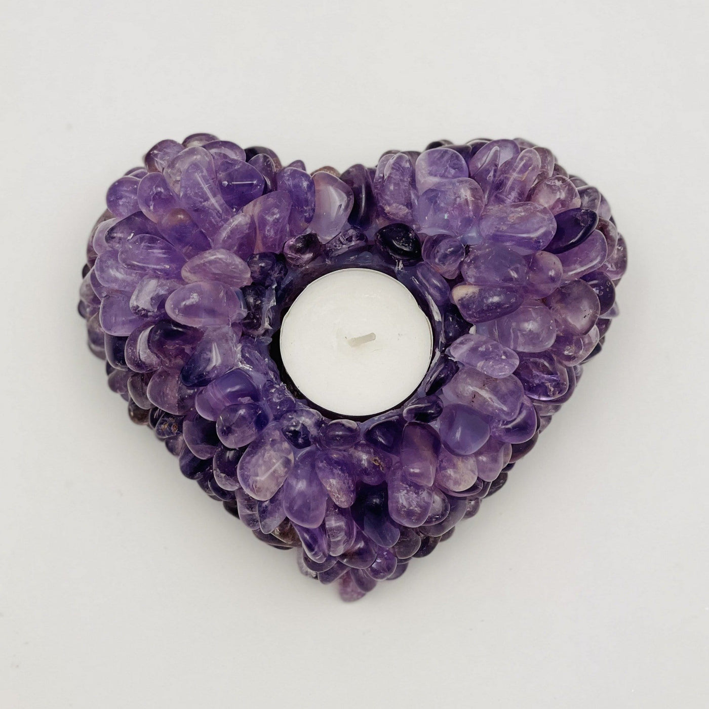 top view of amethyst tumbled stone heart candle holder on white background