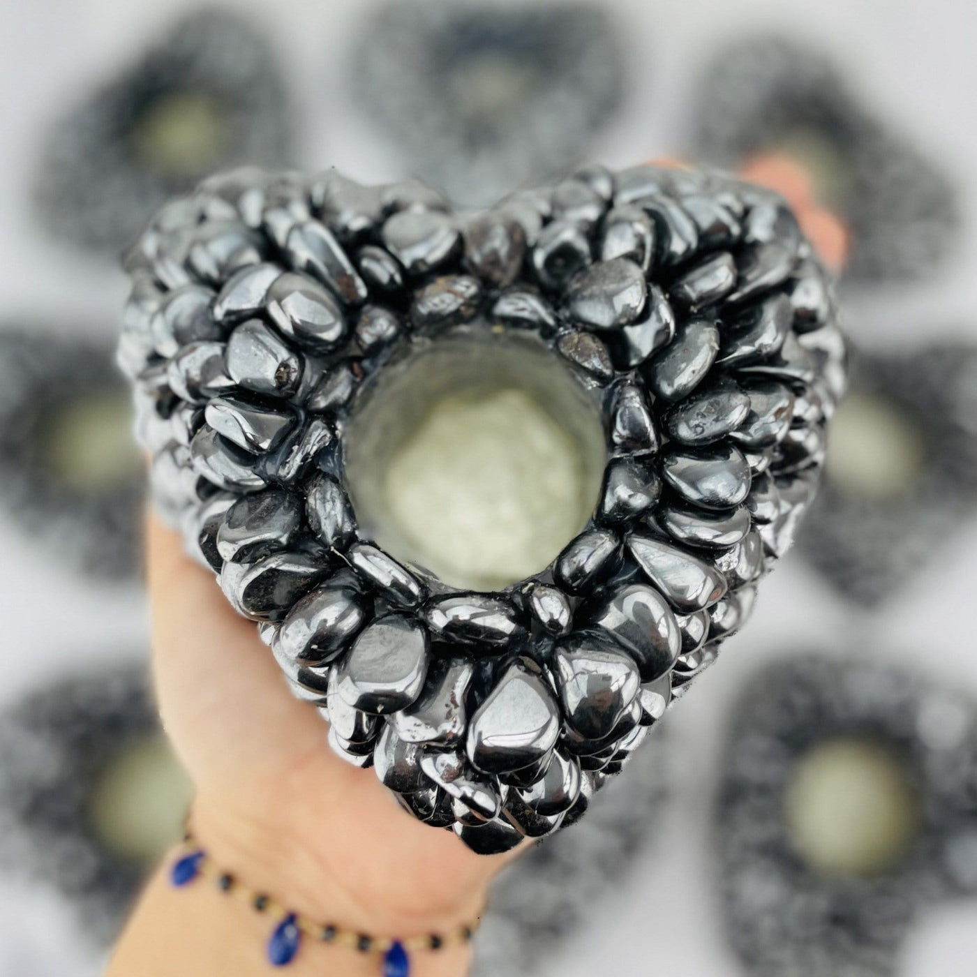 hematite tumbled stone heart candle holder - one held in a hand