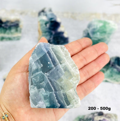 200-500g Fluorite Cut Base Chunk in hand for size reference