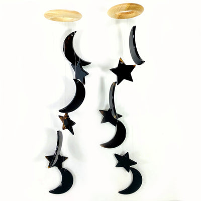 Two black Agate Moon and Star Wind Chimes on a white background.