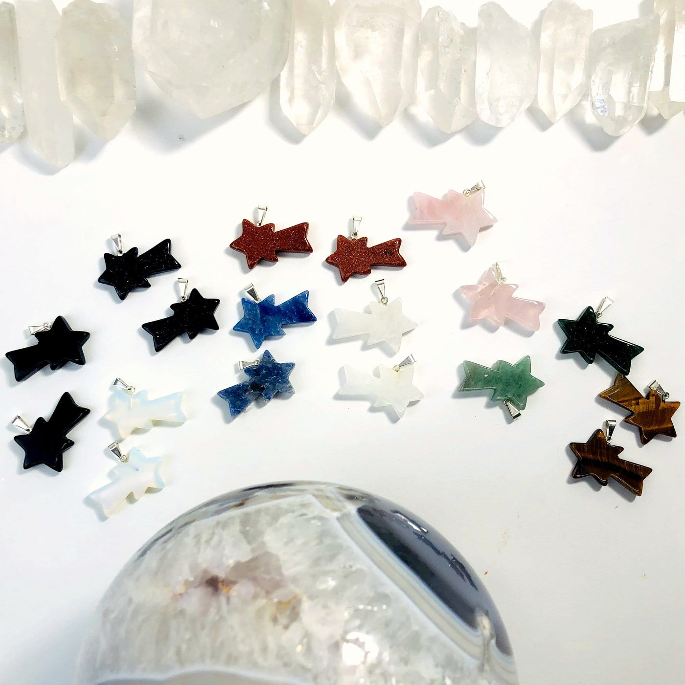 many shooting star stone pendants on display