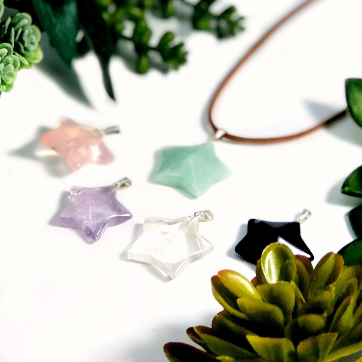 angled shot of Gemstone Star Pendants with Silver Toned Bail with decorations