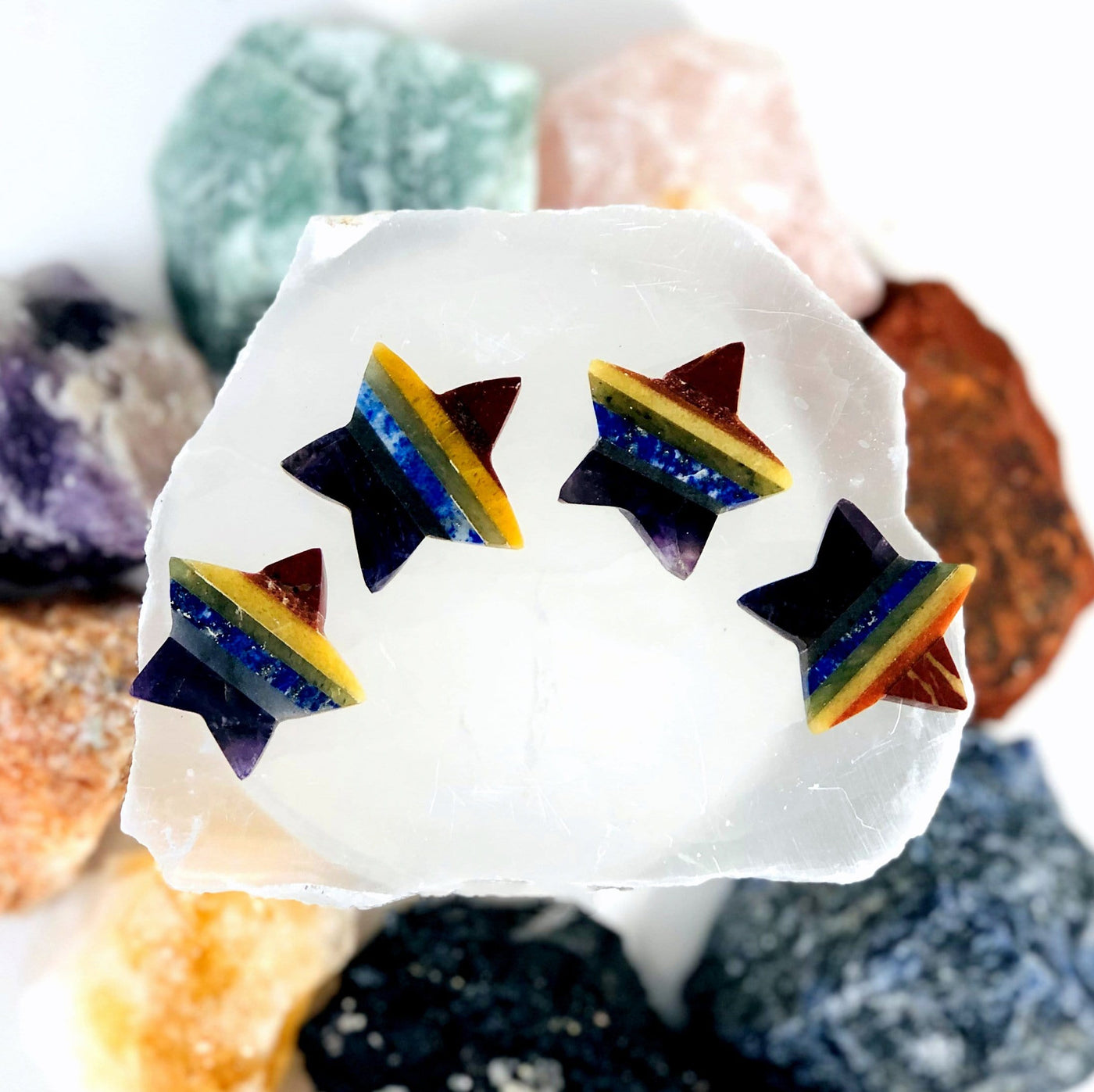 overhead view of four seven chakra stars laying flat on display for possible variations