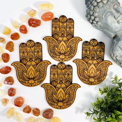 multiple hamsa hand wooden alter display pictured on a white background